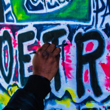 person doing wall graffiti