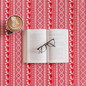 black frame eyeglasses on top of the book