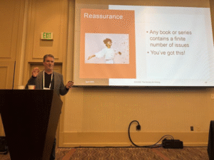 James Gallagher speaking behind a lectern at ACES 2025 in Salt Lake City
